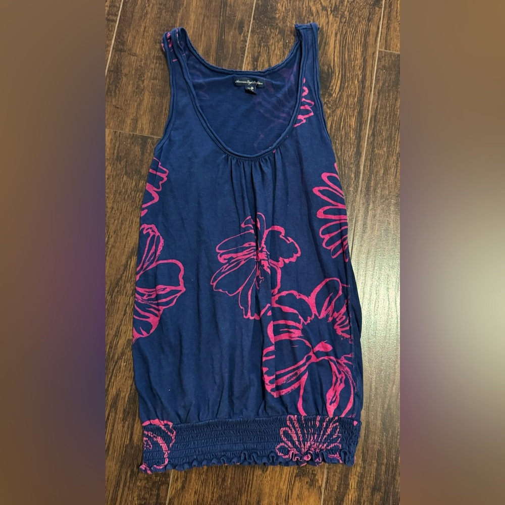Navy tank w/ dark pink floral pattern. Has an elastic band @bottom of tank.